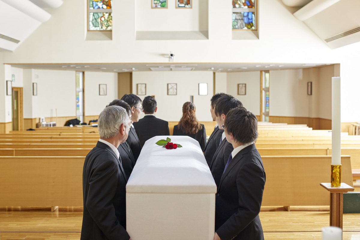 ご遺族で祭壇から寝台車へ棺を運ぶ